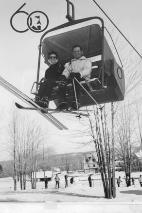 Vintage photo of a couple riding the first bubble chairlift in the world at The Highlands