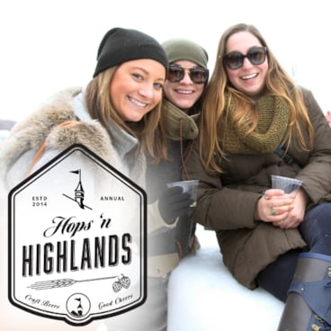 A group posing outside holding beer at The Highlands Hops and Highlands event